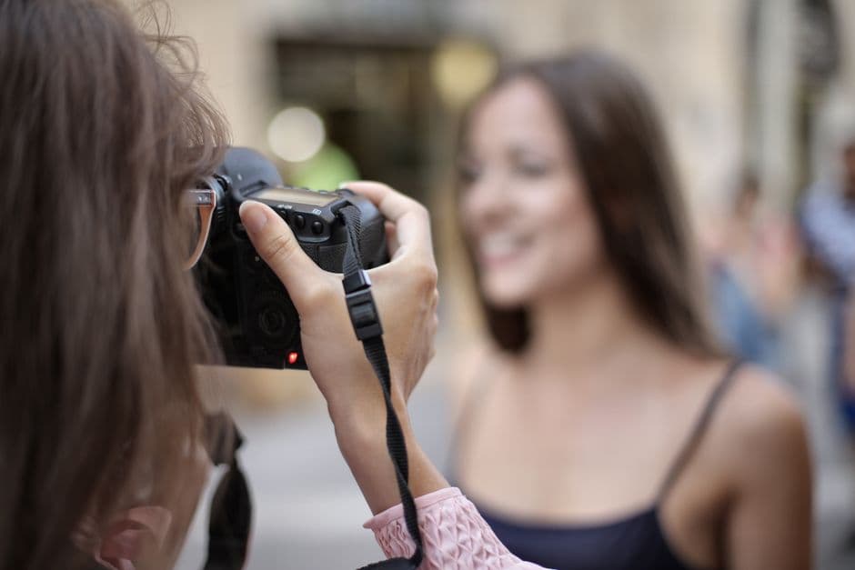 A photographer focusing on a subject with a shallow depth of field