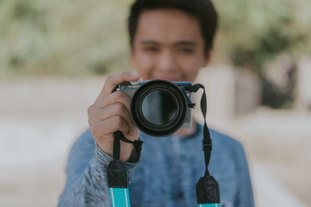 A person holding a mirrorless camera