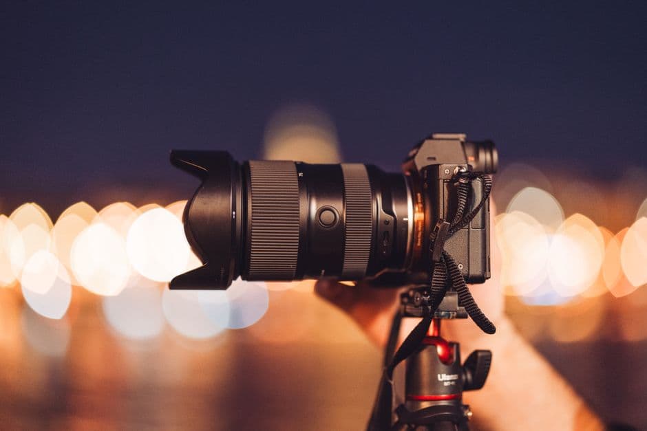 A mirrorless camera held handheld in low light