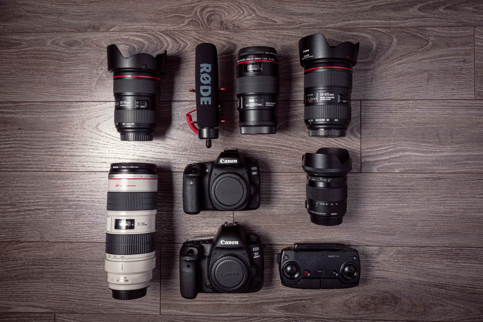 A camera microphone, tripod and SD cards laid out as a creator kit