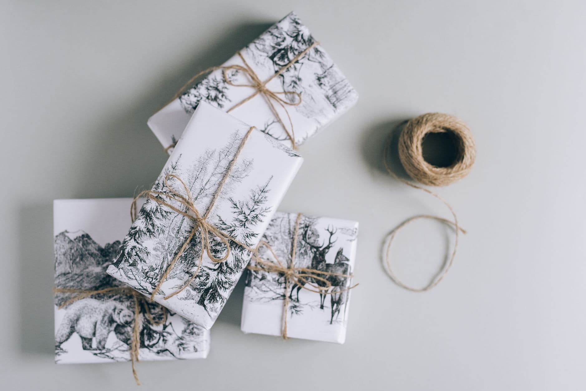 Gift boxes wrapped in plain paper and tied with twine, ready for the holidays